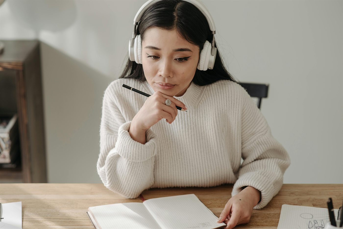 Focused planning with headphones and notebook